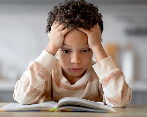 Little boy trying to read